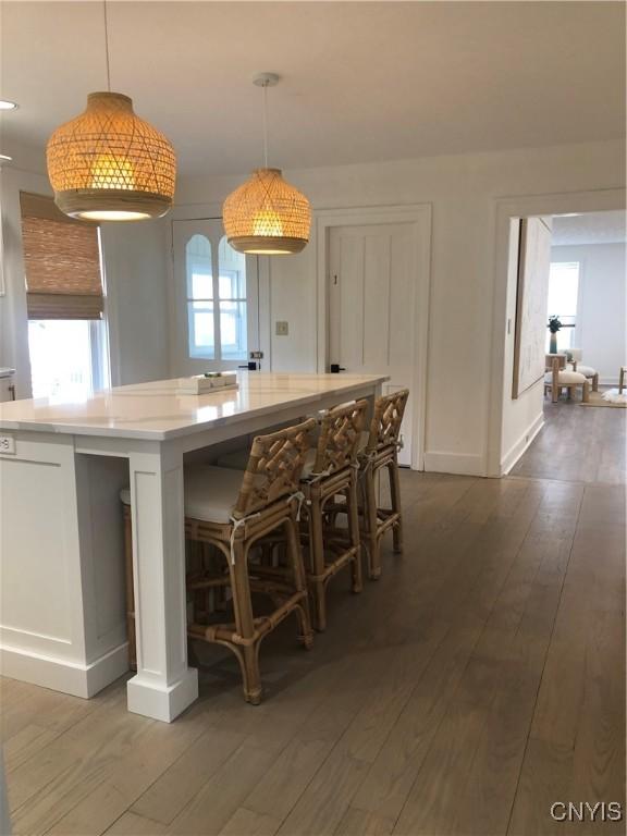 10 Montgomery St, Hamilton, NY 13346 - kitchen featuring dark wood-type flooring, decorative light fixtures, and a center island