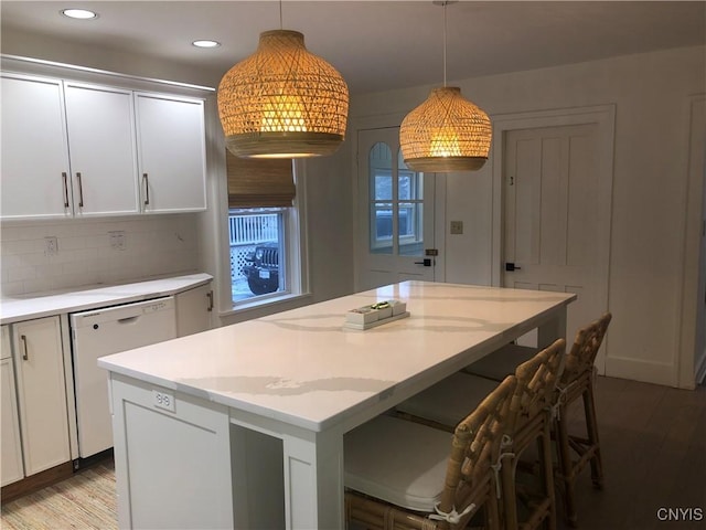 10 Montgomery St, Hamilton, NY 13346 - kitchen with white dishwasher, light countertops, wood finished floors, a center island, and decorative backsplash