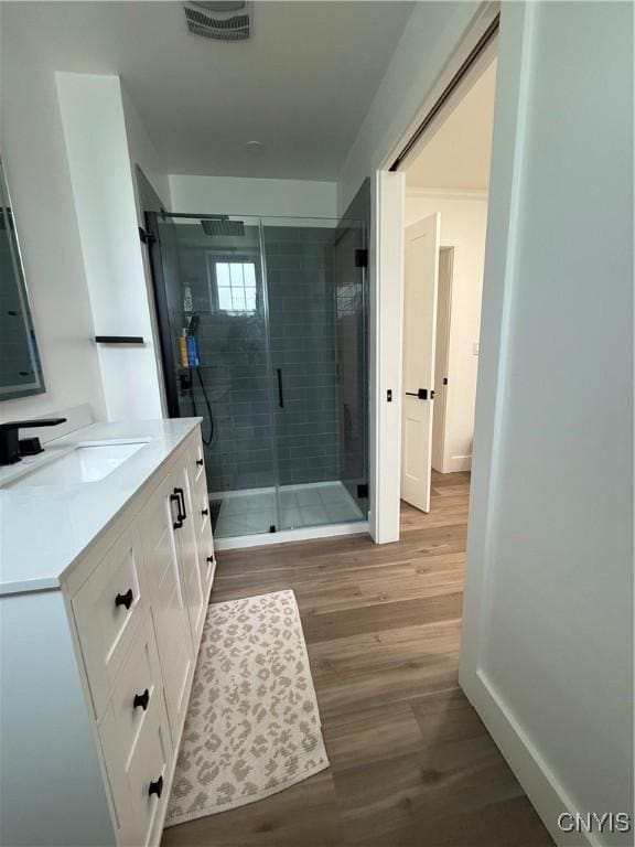 10 Montgomery St, Hamilton, NY 13346 - bathroom featuring vanity, a stall shower, and wood finished floors