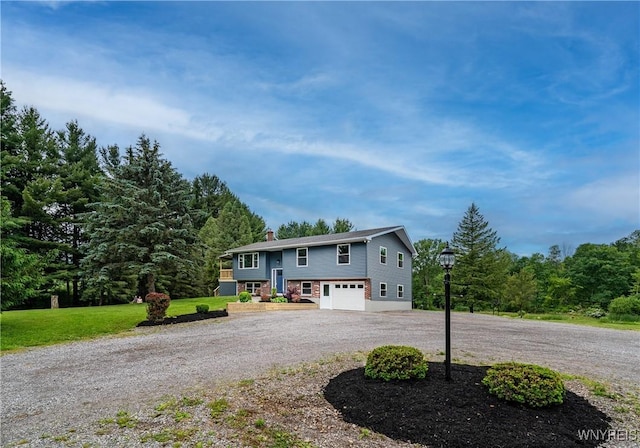 2540 Snyder Rd, Orangeville, NY 14167 - bi-level home featuring curved driveway, an attached garage, and a chimney