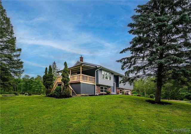 2540 Snyder Rd, Orangeville, NY 14167 - back of property with stairs, a chimney, a yard, and a wooden deck