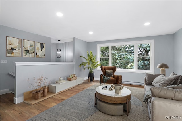 2540 Snyder Rd, Orangeville, NY 14167 - living room with wood finished floors, a baseboard radiator, and recessed lighting