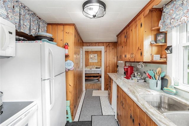 8479 Princeton St, Richmond, NY 14471 - kitchen featuring white appliances, wood walls, brown cabinetry, light countertops, and healthy amount of natural light