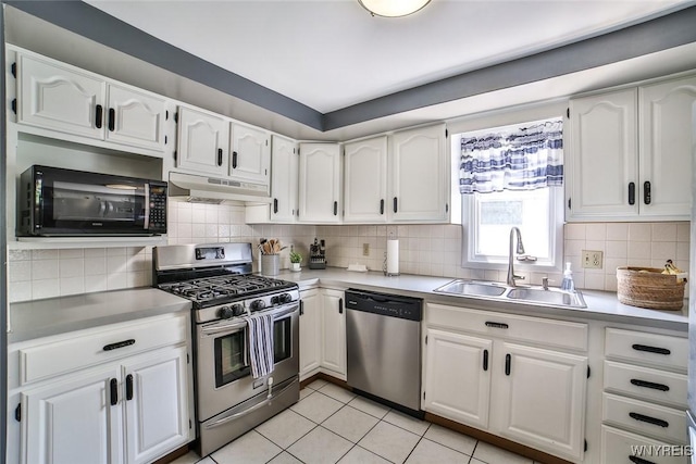 37 Rosary Blvd, Cheektowaga, NY 14225 - kitchen with stainless steel appliances, under cabinet range hood, white cabinetry, and light countertops