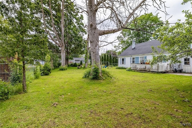 703 Winchester Rd, Dewitt, NY 13057 - view of green lawn with a wooden deck