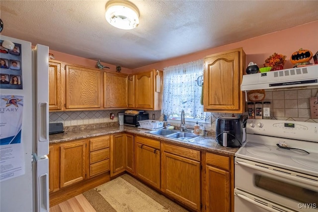 703 Winchester Rd, Dewitt, NY 13057 - kitchen featuring white appliances, extractor fan, decorative backsplash, a textured ceiling, and light wood-style flooring