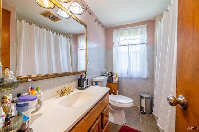 703 Winchester Rd, Dewitt, NY 13057 - bathroom featuring tile walls, vanity, and tile patterned floors