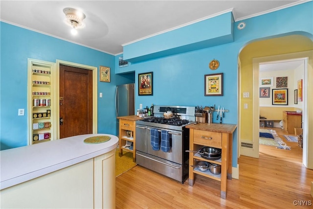 151 Edgehill Rd, Syracuse, NY 13224 - kitchen with double oven range, ornamental molding, light wood finished floors, arched walkways, and light countertops