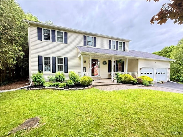 550 Sayles St, Oneida-Inside, NY 13421 - view of front of house with asphalt driveway, covered porch, an attached garage, and a front lawn