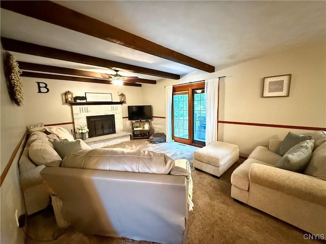 550 Sayles St, Oneida-Inside, NY 13421 - living area featuring carpet floors, a glass covered fireplace, beam ceiling, and a ceiling fan