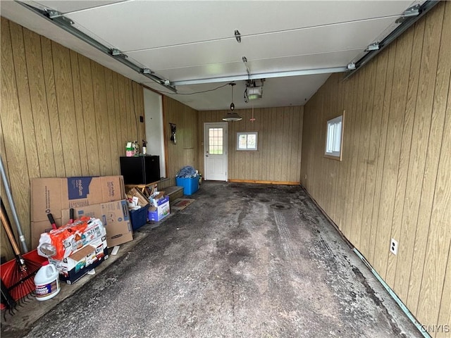 301 Loma Ave, Syracuse, NY 13208 - garage featuring a garage door opener and wooden walls