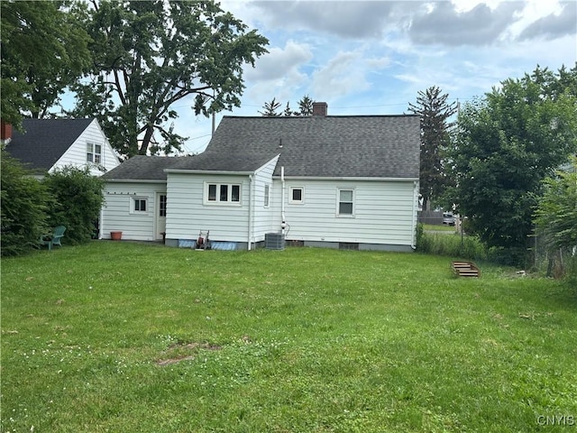 301 Loma Ave, Syracuse, NY 13208 - back of house with a chimney, a yard, and a shingled roof