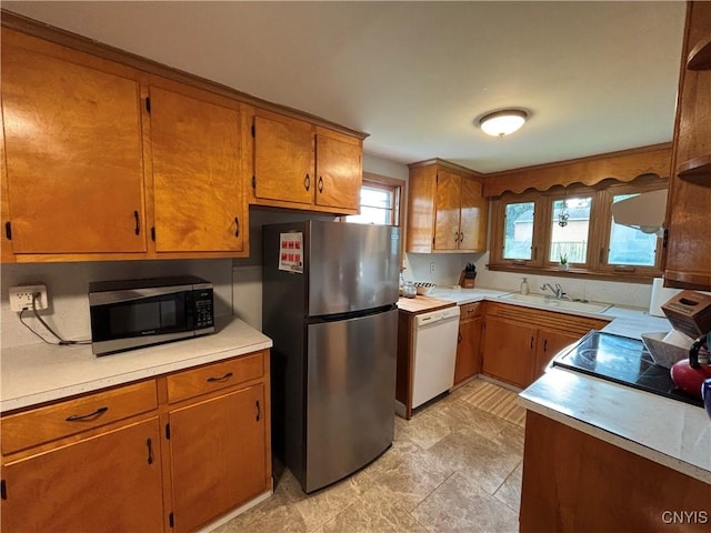 301 Loma Ave, Syracuse, NY 13208 - kitchen with appliances with stainless steel finishes, brown cabinets, light countertops, and open shelves