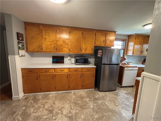 301 Loma Ave, Syracuse, NY 13208 - kitchen with stainless steel appliances, light countertops, and brown cabinets
