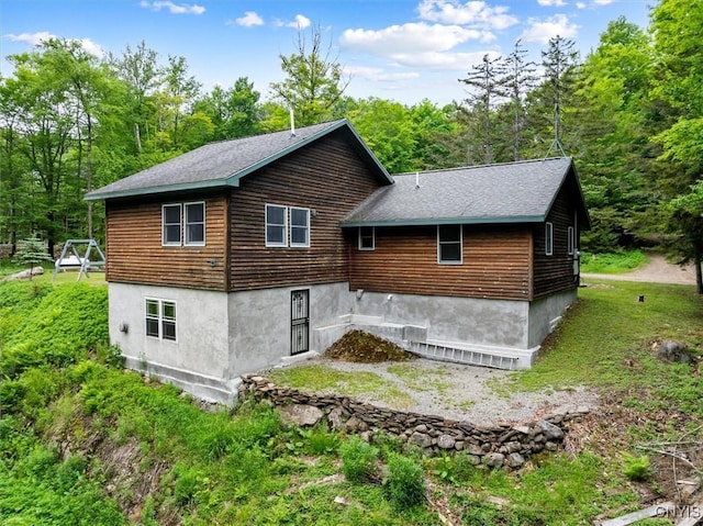 146 Mohawk Dr W, Webb, NY 13420 - rear view of house featuring a view of trees
