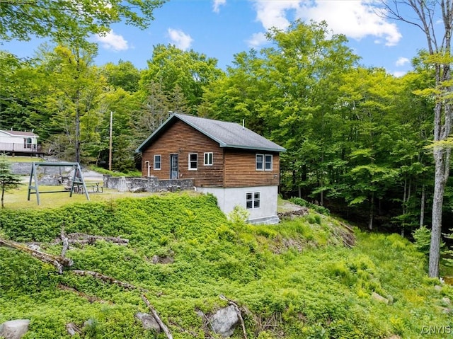 146 Mohawk Dr W, Webb, NY 13420 - rear view of property featuring a wooded view