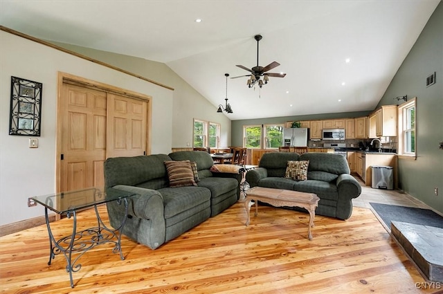 146 Mohawk Dr W, Webb, NY 13420 - living area featuring lofted ceiling, a ceiling fan, and light wood finished floors