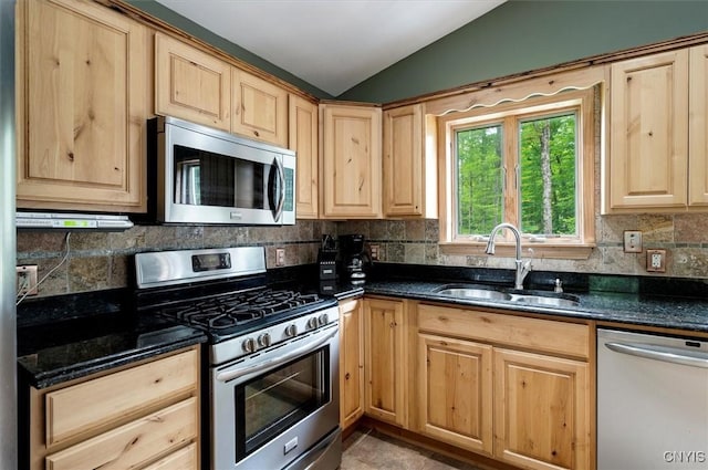 146 Mohawk Dr W, Webb, NY 13420 - kitchen with appliances with stainless steel finishes, light brown cabinets, lofted ceiling, and decorative backsplash