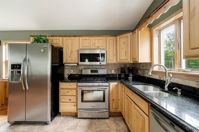 146 Mohawk Dr W, Webb, NY 13420 - kitchen featuring stainless steel appliances, light brown cabinetry, decorative backsplash, dark stone countertops, and lofted ceiling