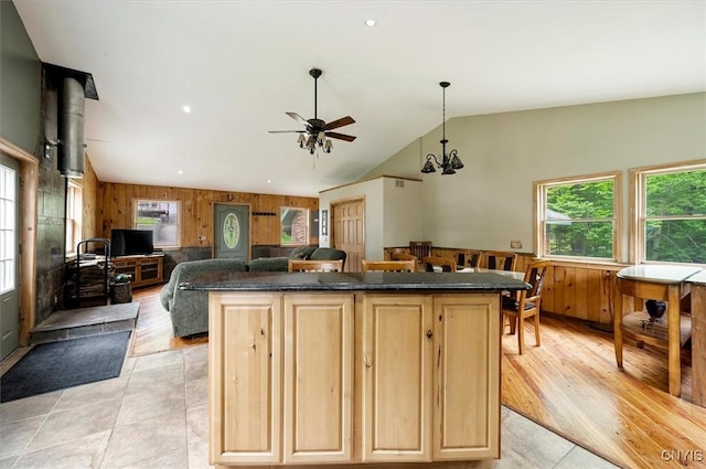 146 Mohawk Dr W, Webb, NY 13420 - kitchen with wooden walls, plenty of natural light, light brown cabinets, a ceiling fan, and a kitchen island