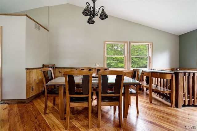 146 Mohawk Dr W, Webb, NY 13420 - dining room with vaulted ceiling, light wood-style flooring, and a chandelier