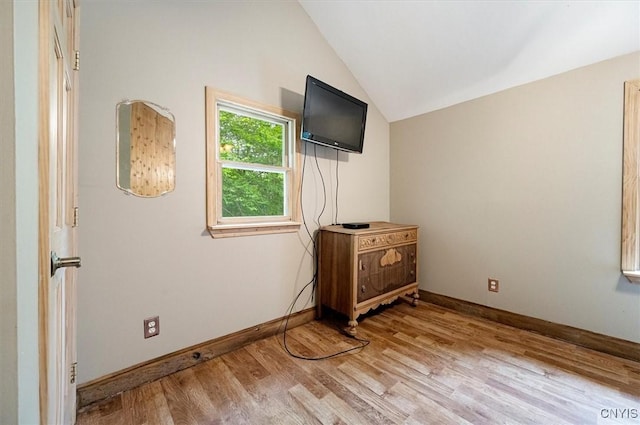 146 Mohawk Dr W, Webb, NY 13420 - unfurnished bedroom with vaulted ceiling and light wood-style floors
