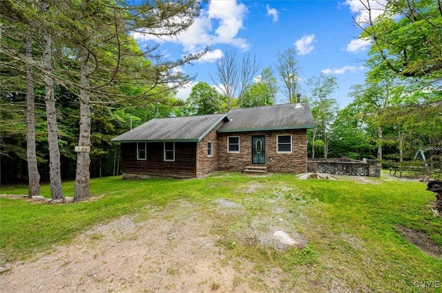 146 Mohawk Dr W, Webb, NY 13420 - view of front of home featuring a front lawn, entry steps, a chimney, and stone siding