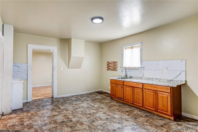 86 Deshler St, Buffalo, NY 14212 - kitchen featuring brown cabinets and decorative backsplash