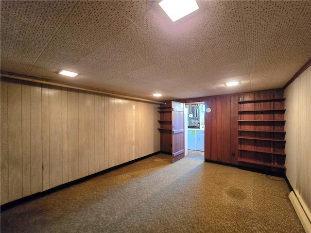 34 Crestview Dr W, Southport, NY 14871 - carpeted spare room with a baseboard radiator, washing machine and clothes dryer, and wood walls