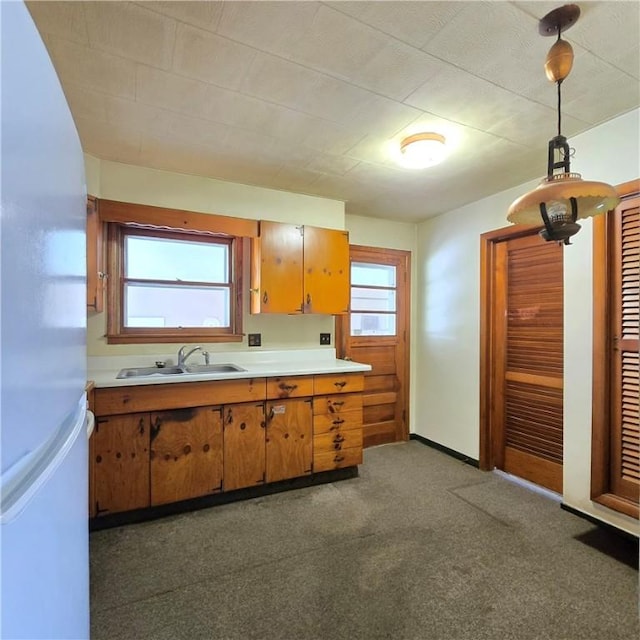 34 Crestview Dr W, Southport, NY 14871 - kitchen with light countertops, brown cabinets, freestanding refrigerator, hanging light fixtures, and dark carpet