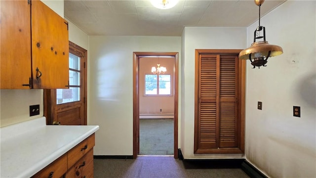 34 Crestview Dr W, Southport, NY 14871 - kitchen with a baseboard heating unit, light countertops, a chandelier, and brown cabinetry