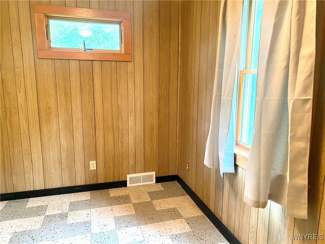 11671 Gowanda State Rd, North Collins, NY 14111 - spare room featuring tile patterned floors and wood walls