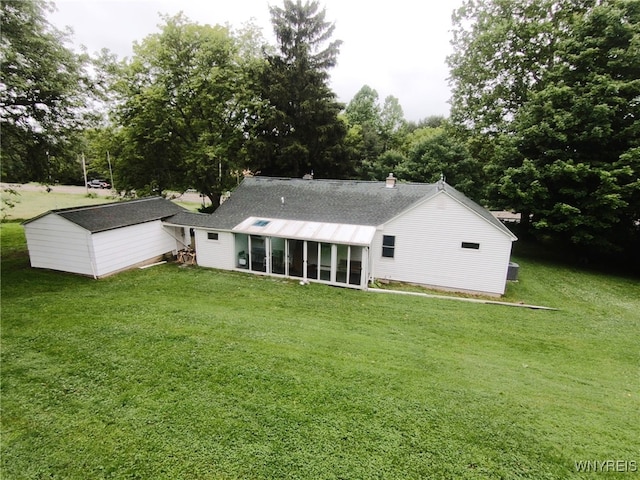 11671 Gowanda State Rd, North Collins, NY 14111 - back of property with a sunroom, a yard, and view of wooded area