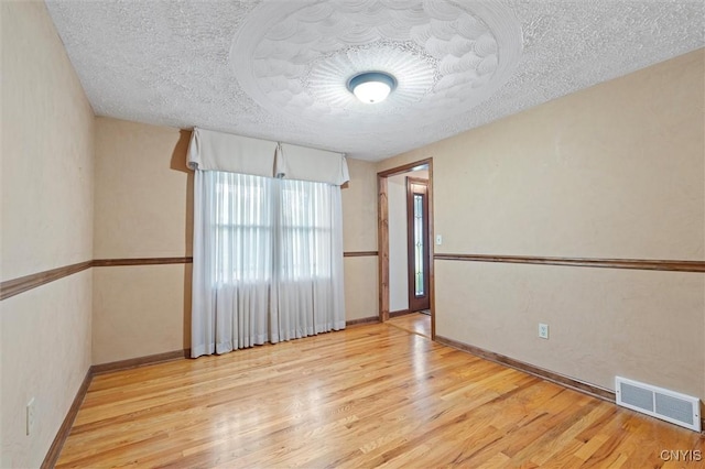 8013 Ginger Rd, Clay, NY 13090 - empty room featuring a textured ceiling and wood finished floors