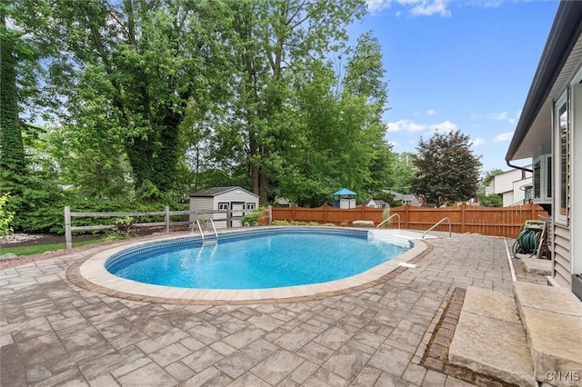 8013 Ginger Rd, Clay, NY 13090 - view of swimming pool featuring a patio area, a fenced backyard, a storage unit, and view of wooded area