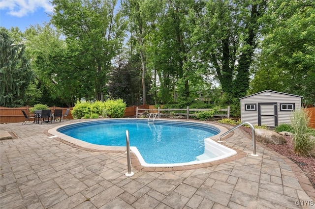 8013 Ginger Rd, Clay, NY 13090 - view of pool featuring a patio, a fenced backyard, a storage shed, and view of wooded area