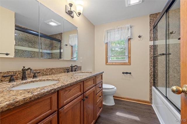 8013 Ginger Rd, Clay, NY 13090 - full bath featuring wood finished floors, double vanity, and enclosed tub / shower combo