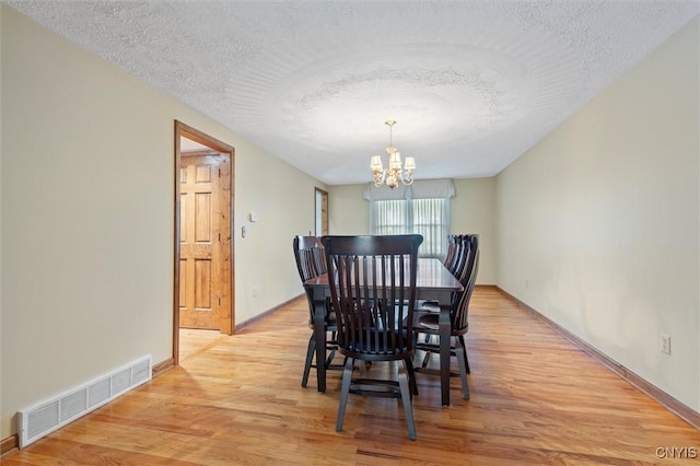 8013 Ginger Rd, Clay, NY 13090 - dining space featuring a chandelier, light wood-style floors, and a textured ceiling