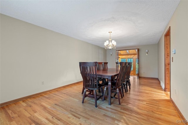 8013 Ginger Rd, Clay, NY 13090 - dining room featuring a chandelier, light wood-type flooring, and a textured ceiling