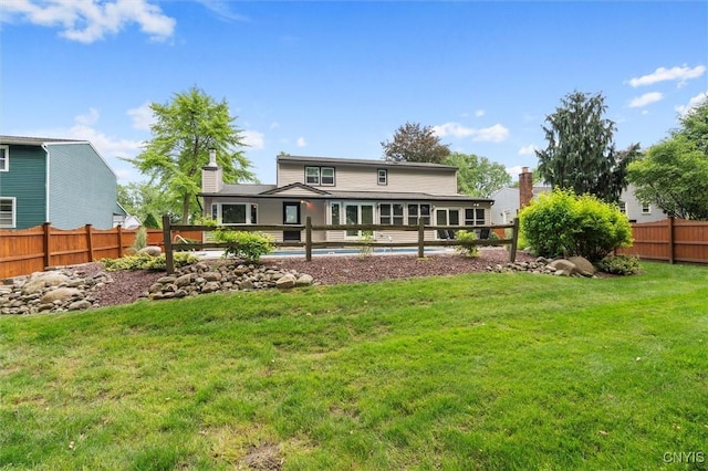 8013 Ginger Rd, Clay, NY 13090 - rear view of house with a fenced backyard and a chimney
