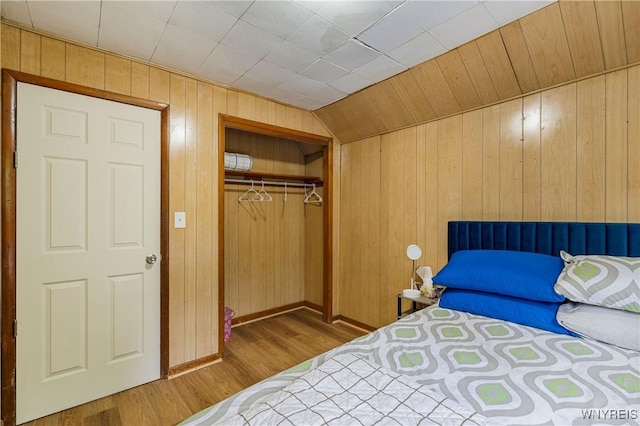 1004 19th St, Niagara Falls, NY 14301 - bedroom with wood finished floors, wood walls, and a closet