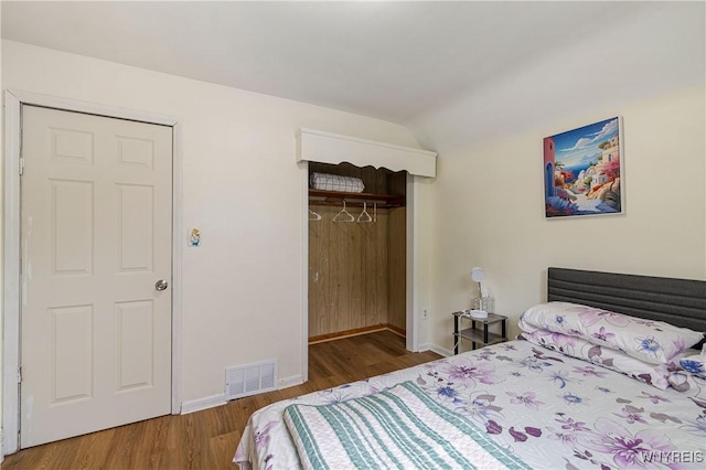 1004 19th St, Niagara Falls, NY 14301 - bedroom featuring wood finished floors, a closet, a walk in closet, and vaulted ceiling