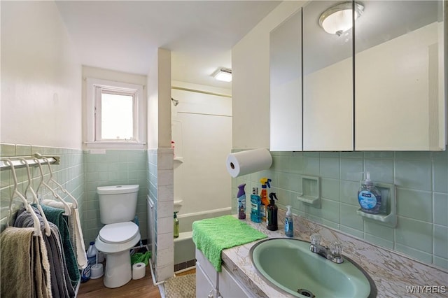 1004 19th St, Niagara Falls, NY 14301 - bathroom featuring vanity, tile walls, wood finished floors, and wainscoting