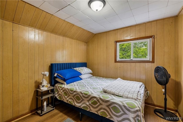 1004 19th St, Niagara Falls, NY 14301 - bedroom with wood finished floors, wooden walls, and vaulted ceiling