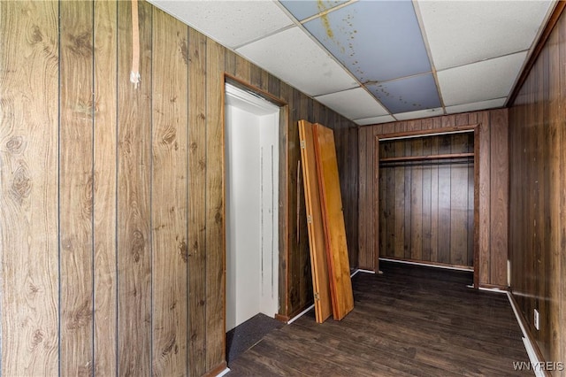 2511 Pine Ave, Niagara Falls, NY 14301 - unfurnished bedroom featuring wooden walls, dark wood-style floors, and a drop ceiling
