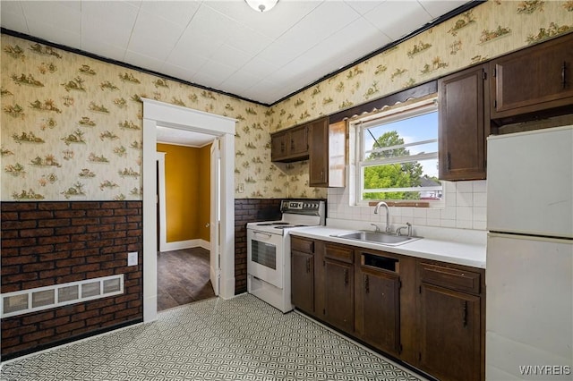 2511 Pine Ave, Niagara Falls, NY 14301 - kitchen with white appliances, wallpapered walls, dark brown cabinets, light countertops, and wainscoting
