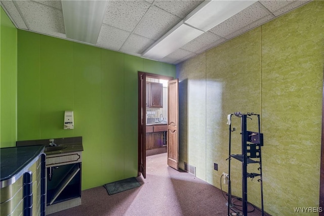 700 Pine Ave, Niagara Falls, NY 14301 - corridor featuring carpet floors, a decorative wall, and a drop ceiling