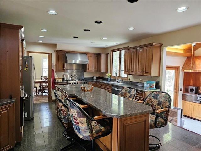 818 Larchmont Cir, Elmira, NY 14905 - kitchen featuring wall chimney range hood, a breakfast bar, stainless steel appliances, recessed lighting, and a center island