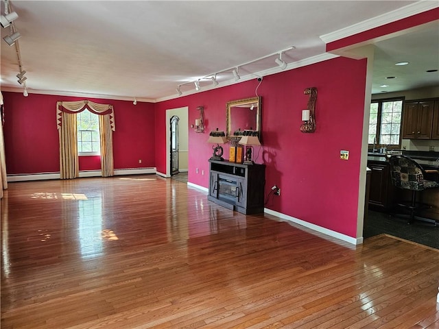 818 Larchmont Cir, Elmira, NY 14905 - unfurnished living room featuring rail lighting, hardwood / wood-style flooring, and crown molding