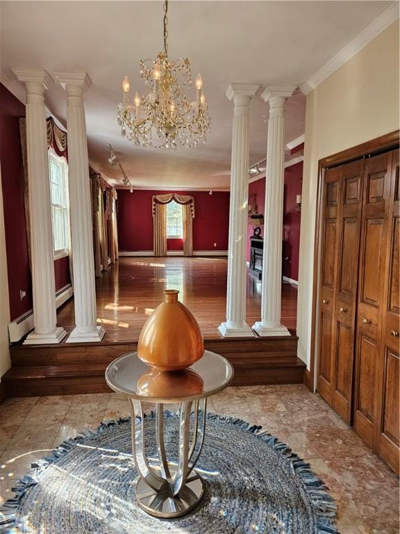 818 Larchmont Cir, Elmira, NY 14905 - foyer entrance with decorative columns, ornamental molding, and a chandelier